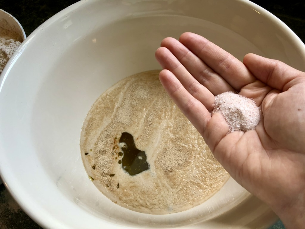 adding salt to pizza dough